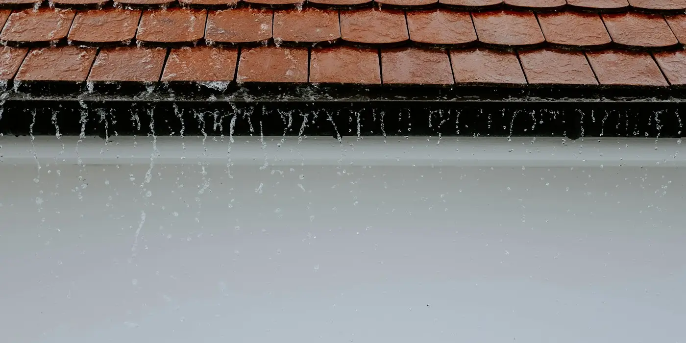 Pluie battante ruisselant sur les tuiles d’un toit